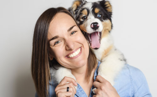 woman with pet dog on her shoulders